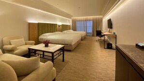 A hotel room with a large bed, a smaller bed, a sofa, a desk, and a TV. - The Sherwood Taipei (Taipei)