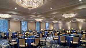 A large banquet hall with round tables, chairs, and chandeliers. - The Westin San Antonio North (San Antonio)