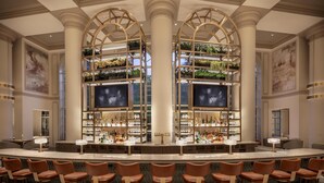 A bar area with multiple seating arrangements and a central shelving unit displaying plants. - Grand Hyatt Atlanta in Buckhead (Atlanta)