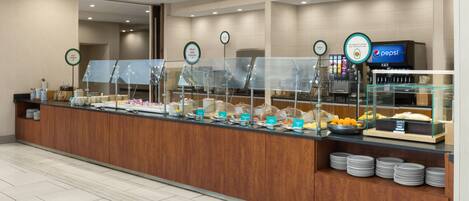 A buffet area with various food stations, including a fruit and yogurt section, and a Pepsi refrigerator.