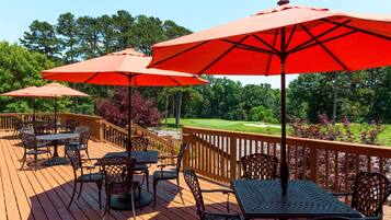 Relax on the deck with comfortable outdoor furniture and enjoy the view of the manicured lawn and golf course.