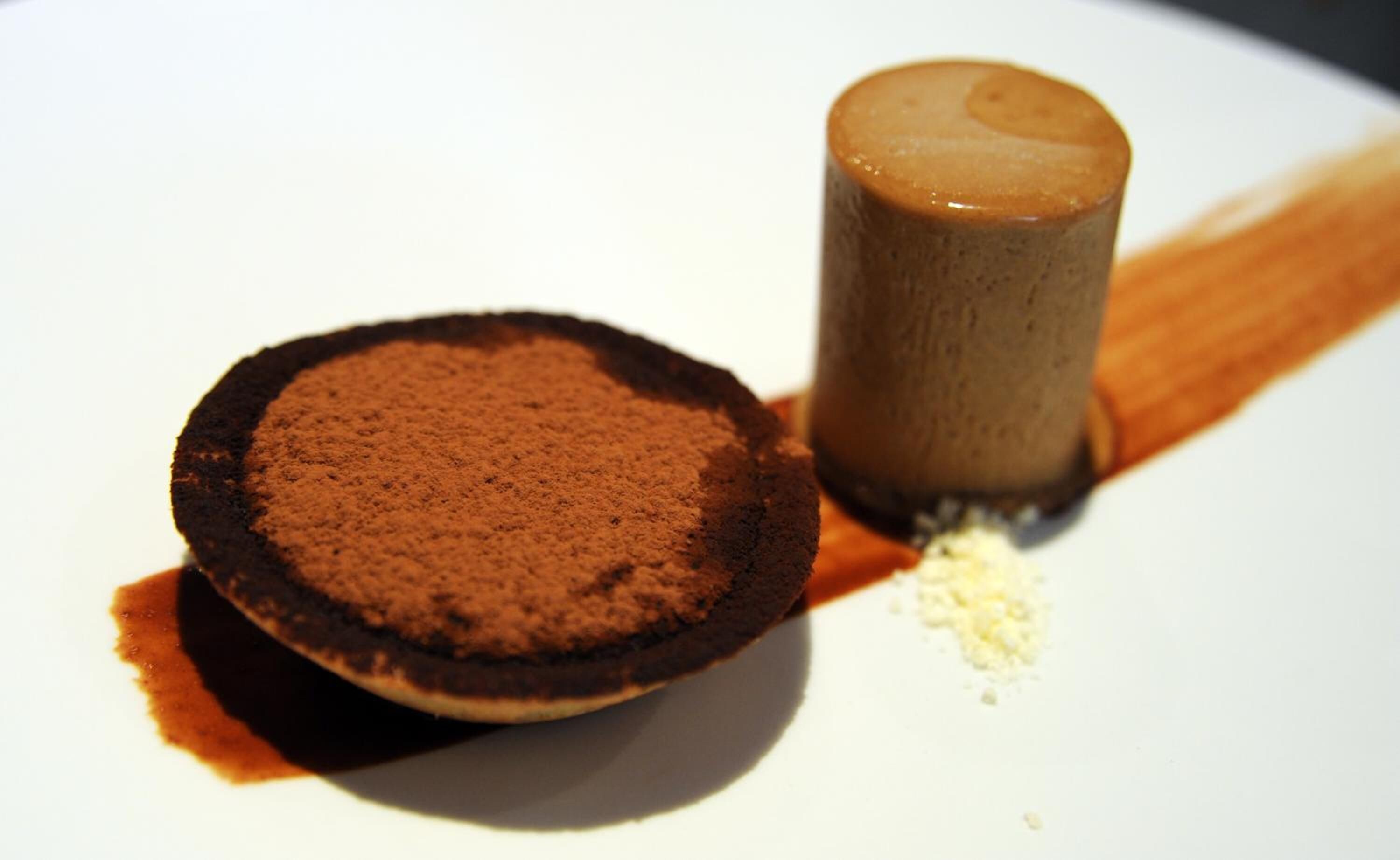 A dessert consisting of a chocolate tart and a chocolate mousse.