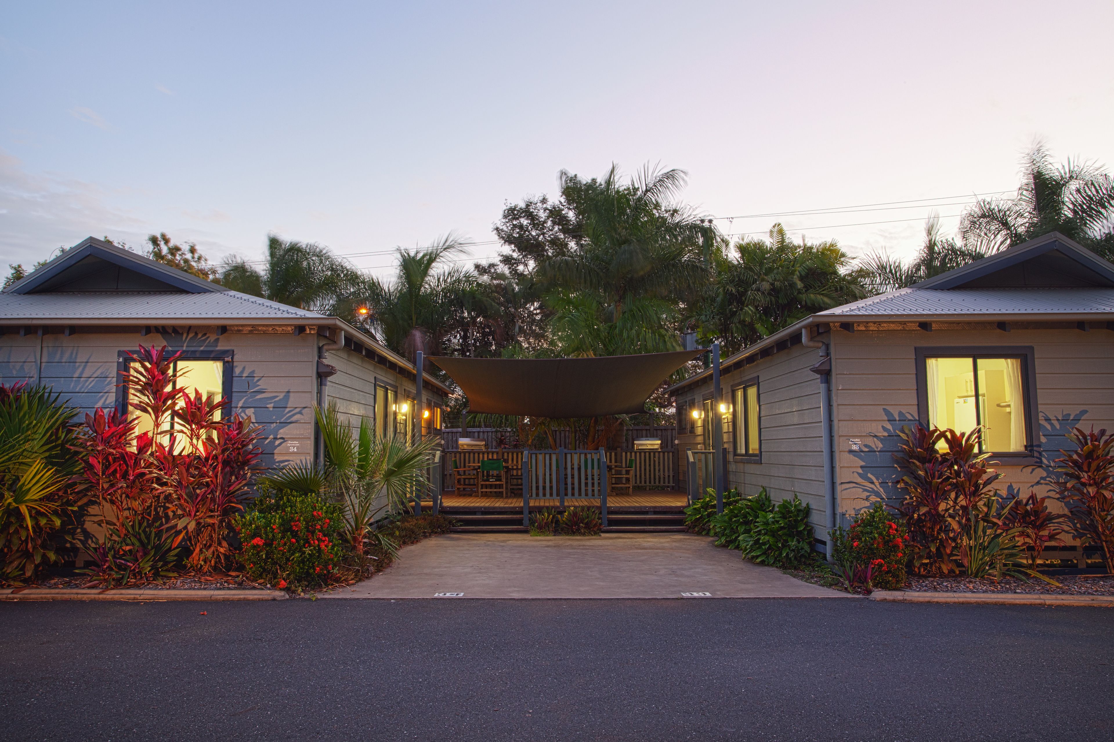 A two-story building with a covered entrance and a small deck area.