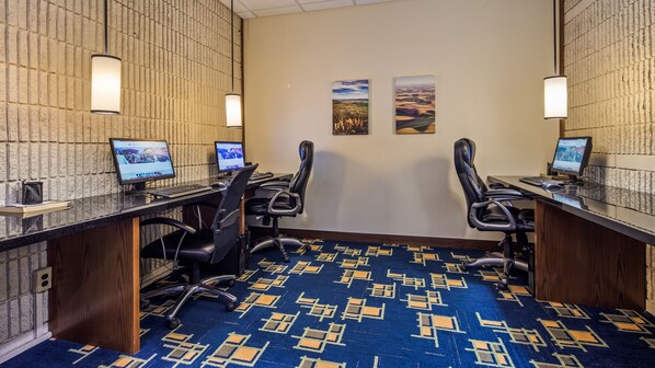A conference room with two desks, each with a computer and chair, and a patterned carpet. - Best Western Plus University Inn (Moscow)