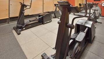 A gym with various exercise equipment including treadmills and ellipticals.