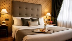 A hotel room with a large bed, two bedside tables, a tray with breakfast items, and a wall clock. - NSM Hotel Cicolella (Foggia)