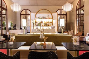 A hotel lobby with a bar area, seating arrangements, and decorative elements. - Carlton Hotel Lyon - MGallery Collection (Lyon)
