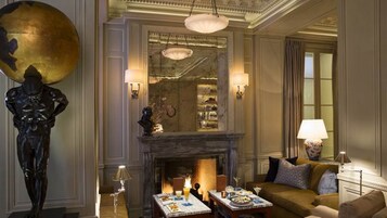 A well-appointed lounge with a fireplace, elegant furniture, and decorative lighting.
