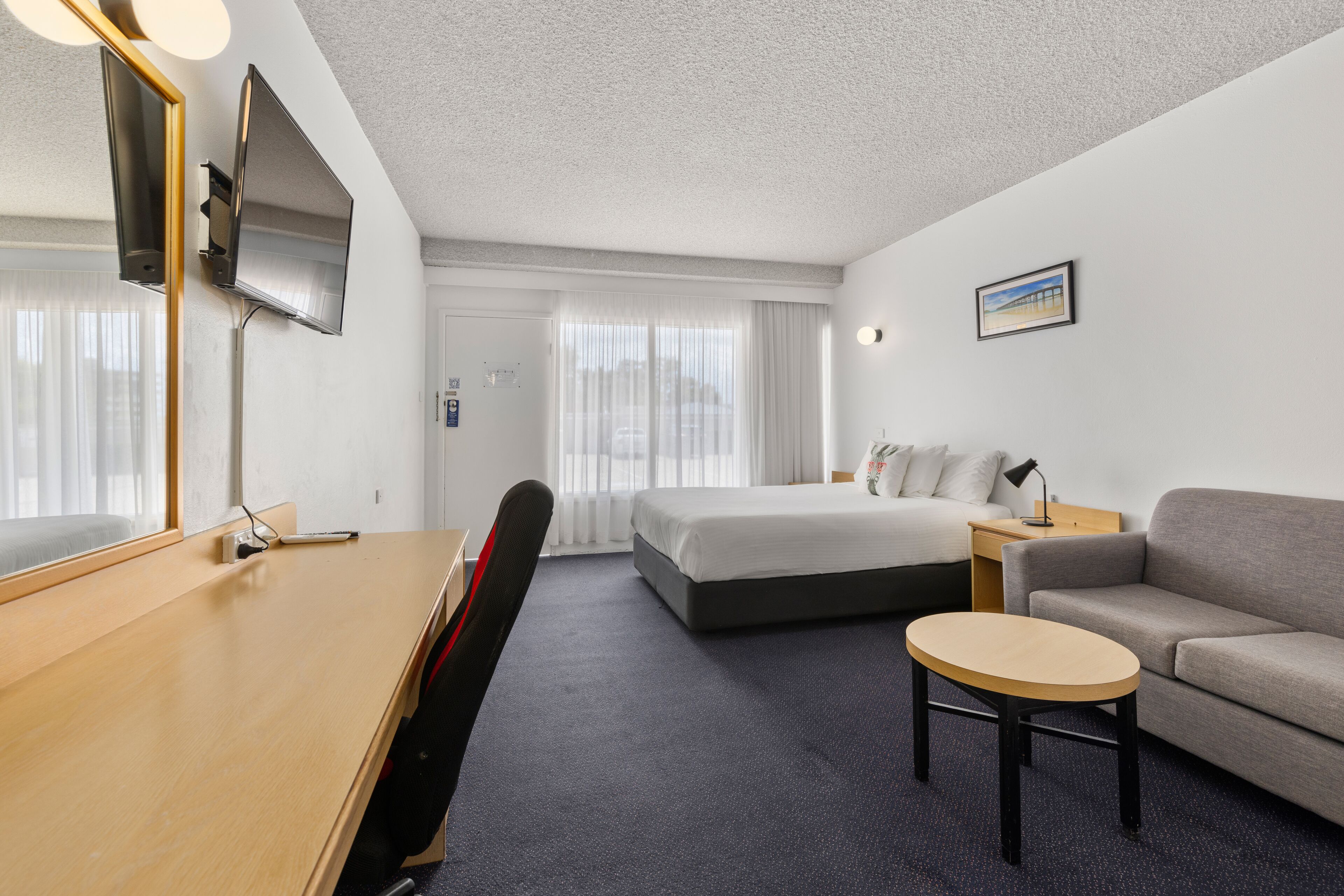 premium bedding, desk, laptop workspace, blackout curtains