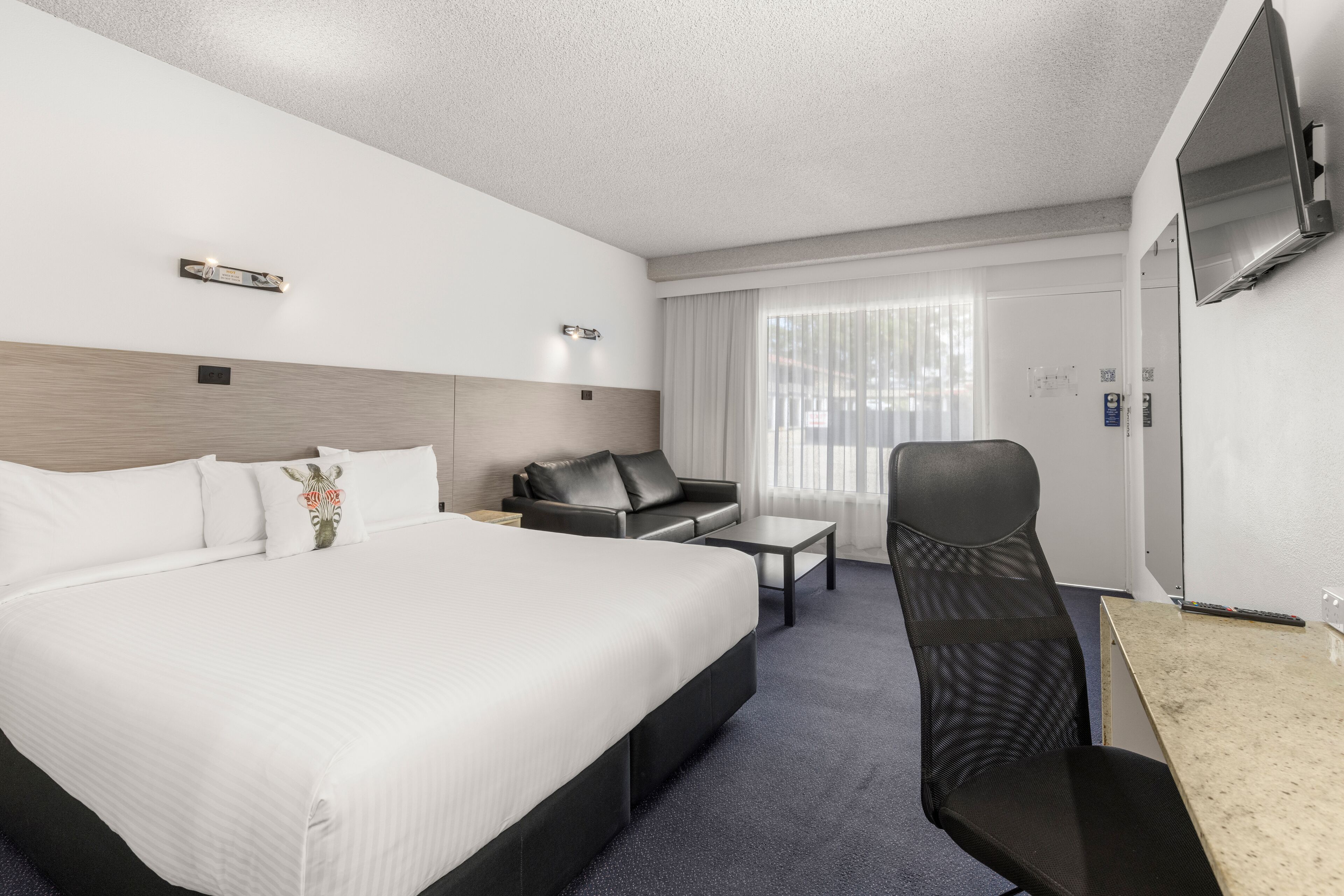 premium bedding, desk, laptop workspace, blackout curtains