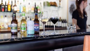 A bar with various bottles and glasses of beverages on the counter. - Zebra Motel   (Coffs Harbour)