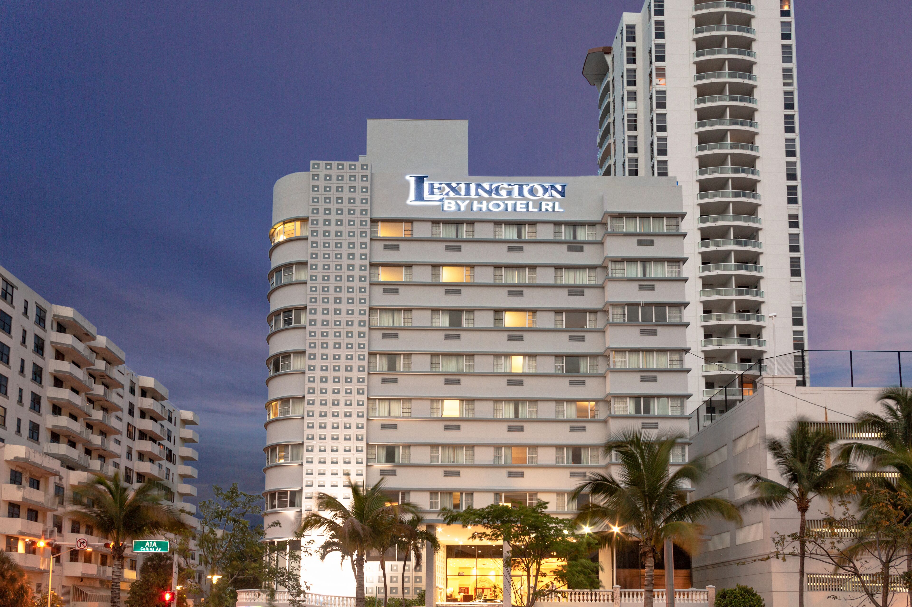 A multi-story hotel with a prominent sign reading "Lexington by HotelRL".