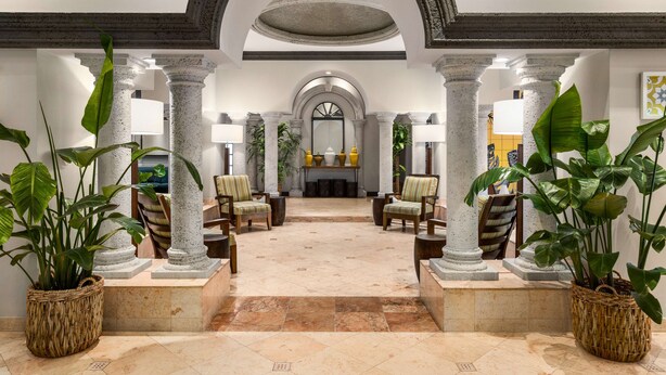 A lobby with a central seating area, columns, and potted plants. - Lexington by Hotel RL Miami Beach (Miami Beach)