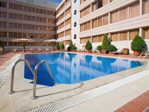 Seasonal outdoor pool, open noon to 9:00 PM, pool umbrellas