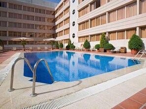 Seasonal outdoor pool, open noon to 9:00 PM, pool umbrellas