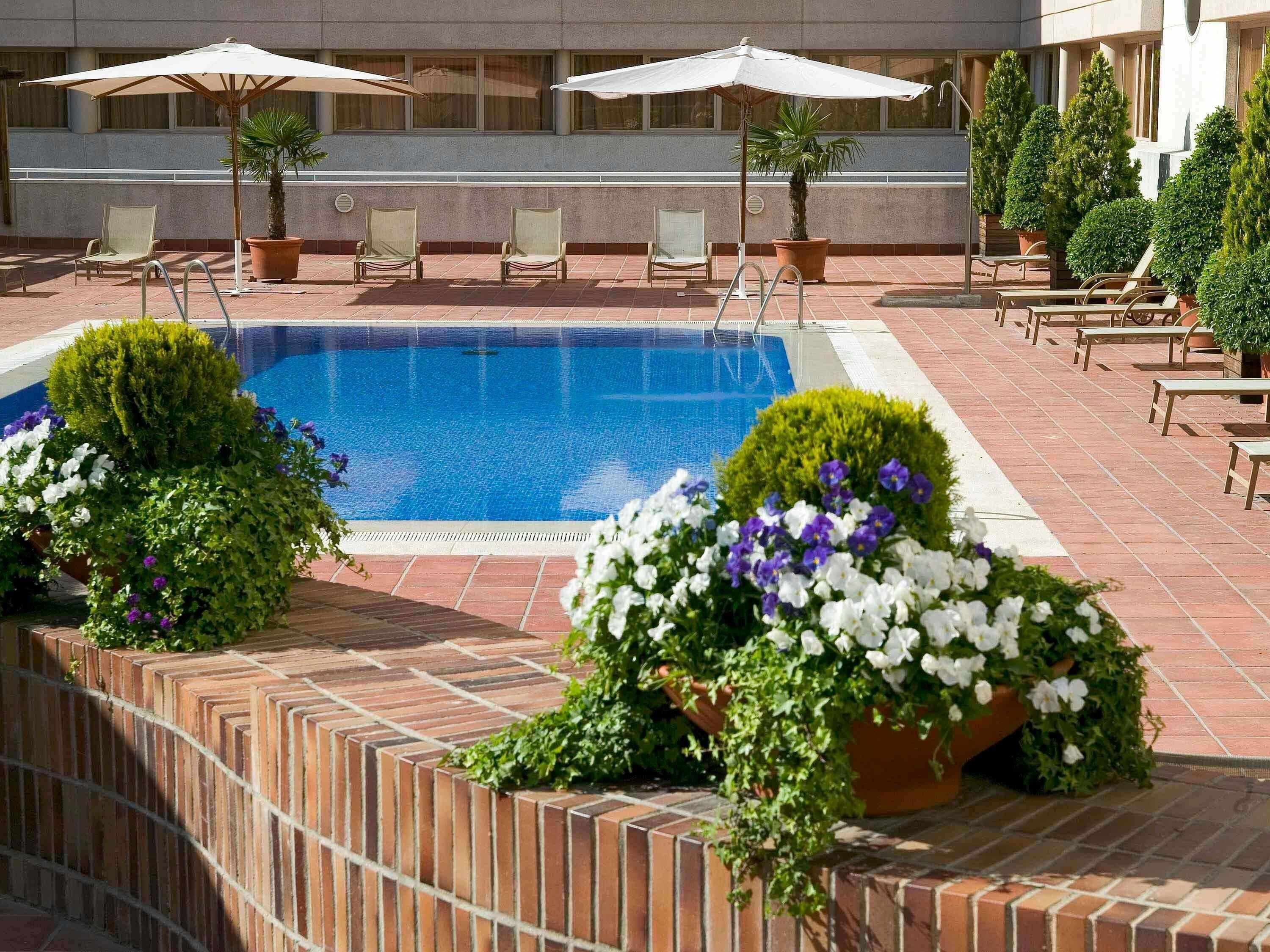 Seasonal outdoor pool, open noon to 8:00 PM, pool umbrellas