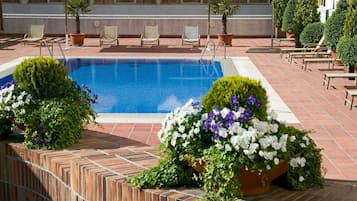 Seasonal outdoor pool, open noon to 8:00 PM, pool umbrellas