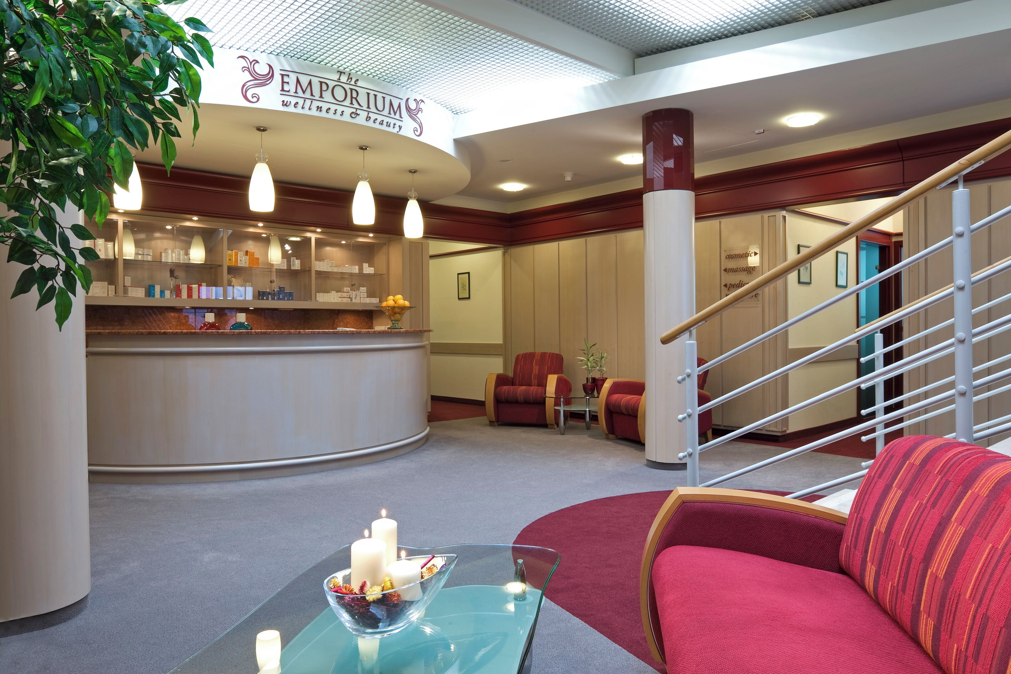 A reception area with a counter, seating, and a staircase.