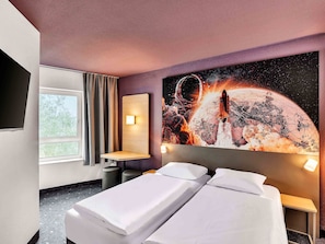 A hotel room with two beds, a large wall mural of a space scene, a window with curtains, and a small table. - B&B Hotel Bremen-Altstadt (Bremen)