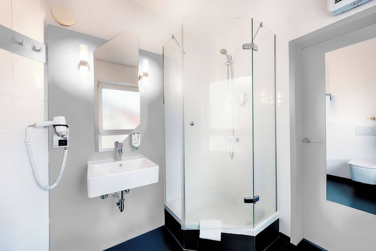 premium double room | bathroom | shower, hair dryer, towels, soap