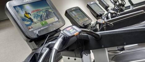A treadmill with a Life Fitness digital display and a heart rate monitor.