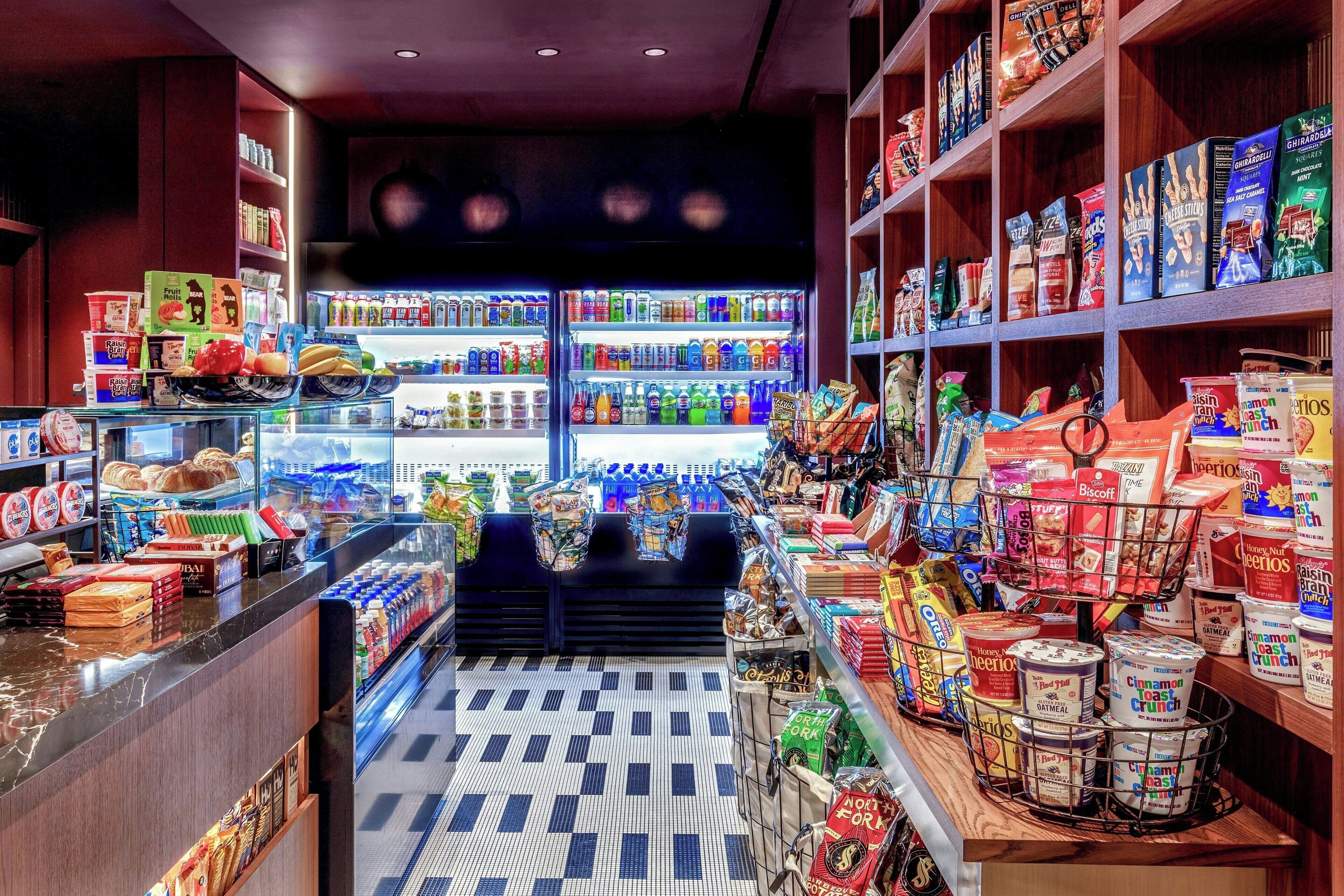 A grocery store with shelves stocked with various food items and a refrigerated section.