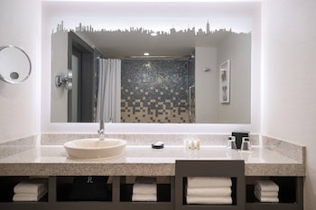 Shower, designer toiletries, hair dryer, towels at Renaissance New York Times Square Hotel by Marriott