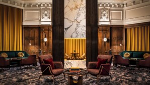 A luxurious lobby with a marble column, plush seating, and a central table with a book titled "Polo Heritage". - Fairmont Chateau Laurier (Ottawa)