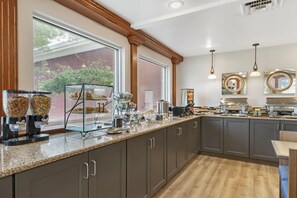 A kitchen with a granite countertop, stainless steel appliances, and a view of the outdoors. - Best Western Plus Burley Inn & Convention Center (Burley)
