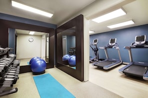 A gym with treadmills, exercise balls, and weight machines. - Embassy Suites by Hilton Lompoc Central Coast (Lompoc)