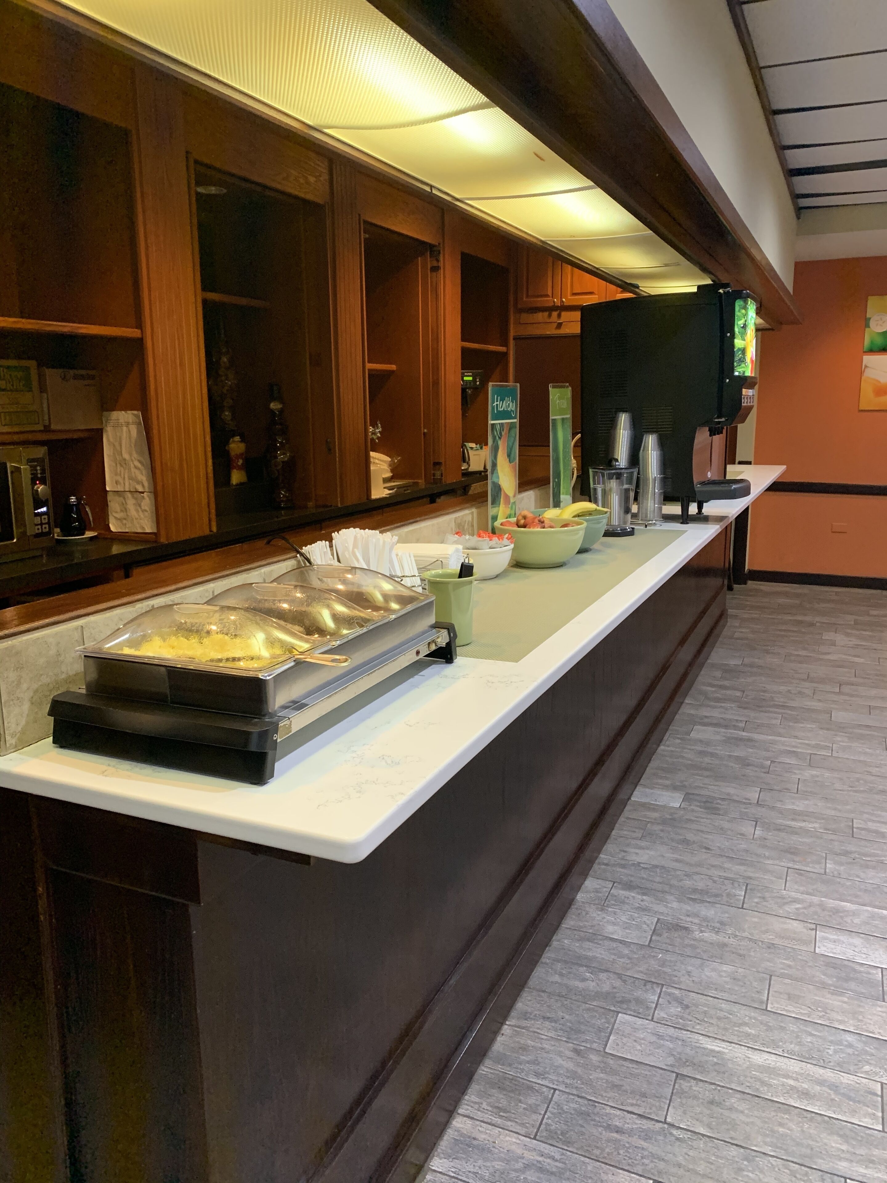 A buffet setup with a variety of food items and a coffee machine.