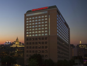 A large hotel building with a prominent sign at the top. - Hilton Garden Inn Austin Downtown (Austin)