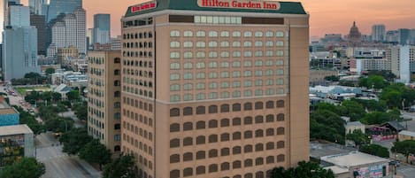 A Hilton Garden Inn with a modern design, multiple floors, and a prominent sign.