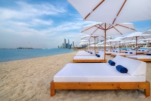 On the beach, white sand, beach towels, beach bar