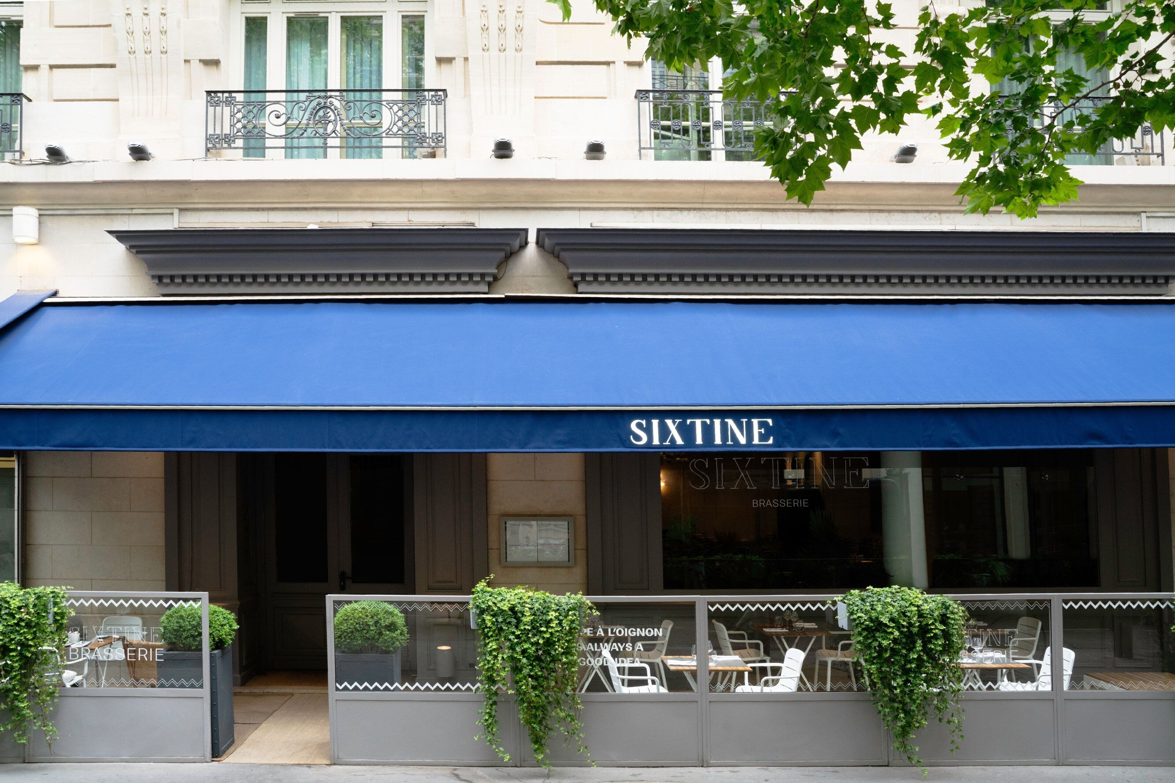 A restaurant named SIXTINE with outdoor seating and decorative plants.