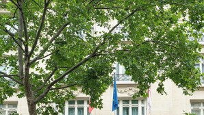A hotel entrance with a large archway, columns, and a sign that reads "HOTEL AMBASSADOR". - Paris Marriott Opera Ambassador (Paris)