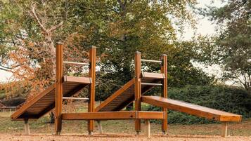 Guests can enjoy a fun outdoor workout on this multi-level climbing frame in the park.