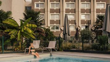 Seasonal outdoor pool, pool umbrellas, pool loungers