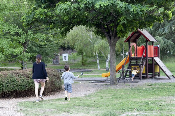 A playground with a slide and climbing structures.
