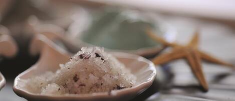 A bowl of salt with a starfish in the background.