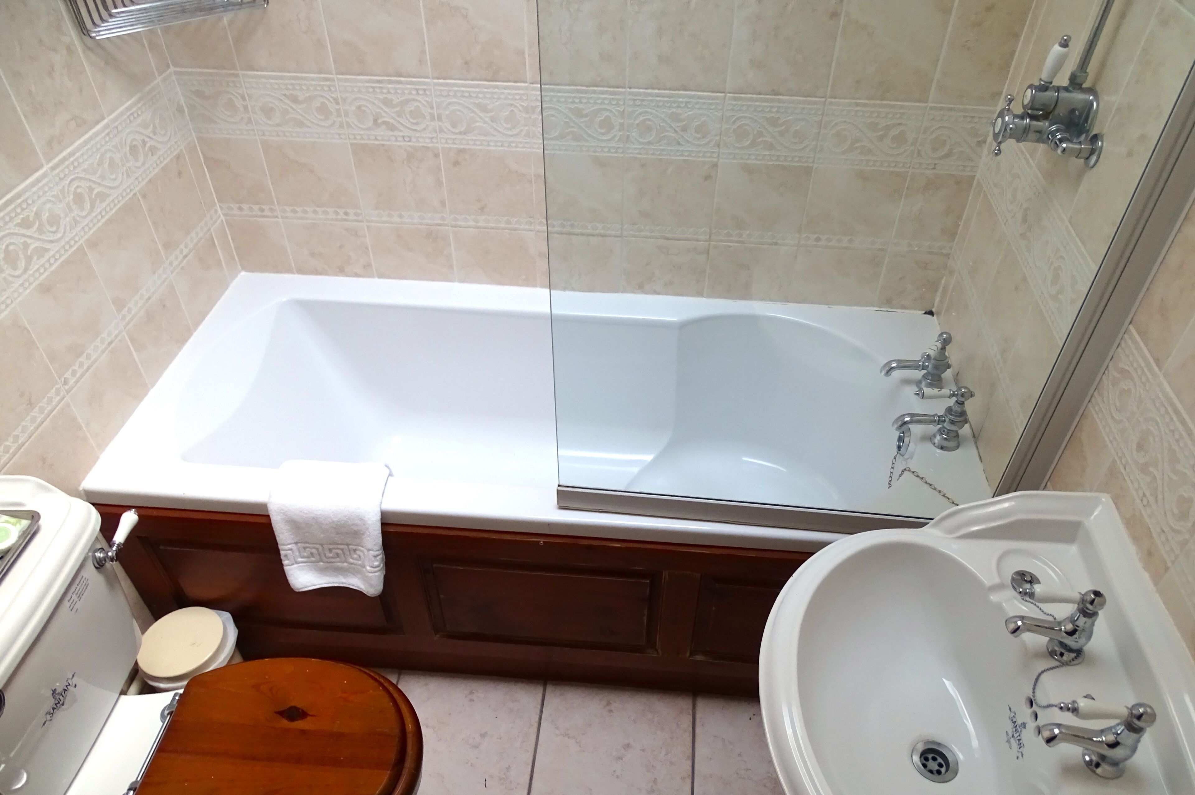 A bathroom with a bathtub, a toilet, and a sink.