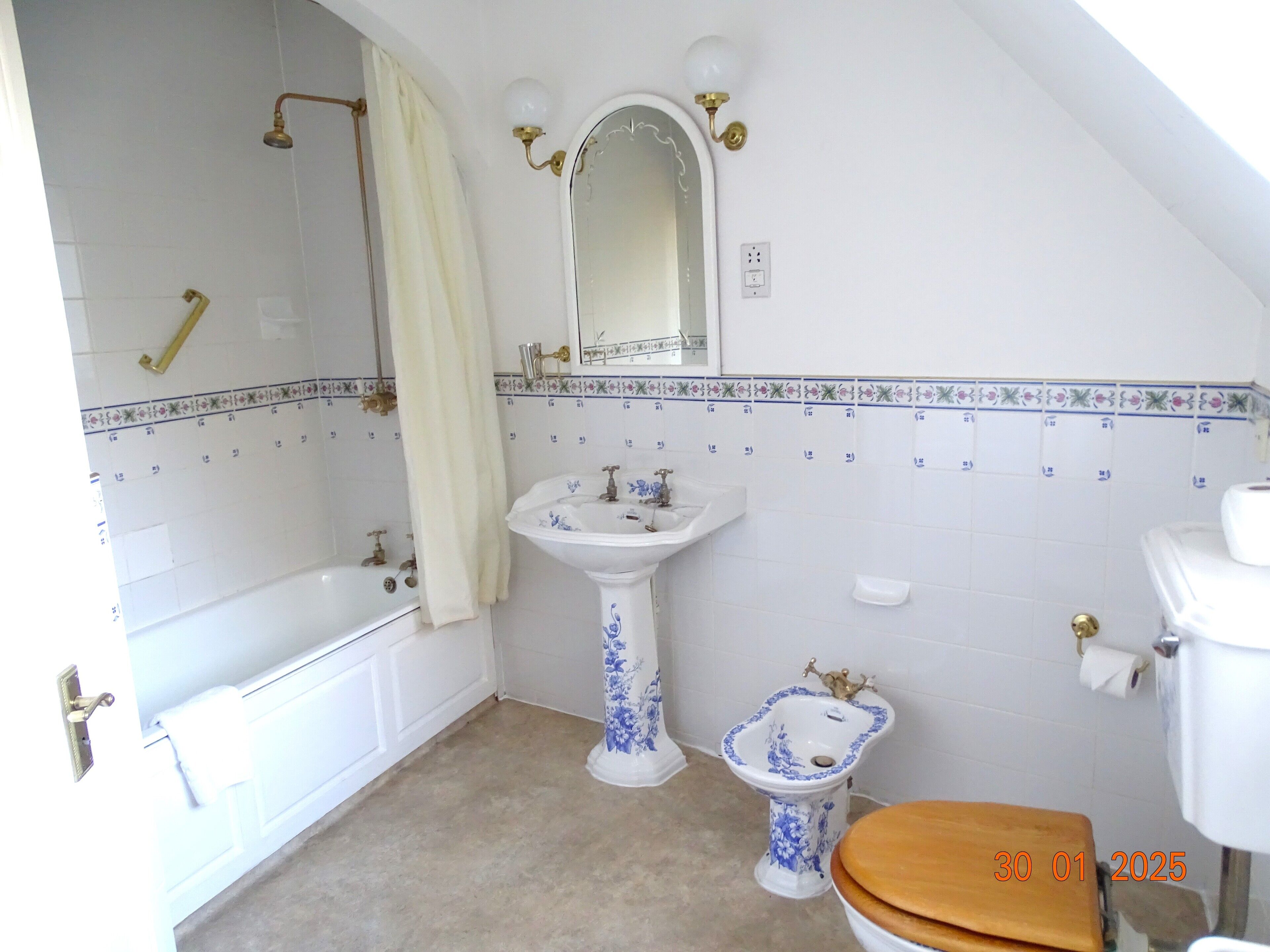 A bathroom with a bathtub, a pedestal sink, a toilet, and a shower.
