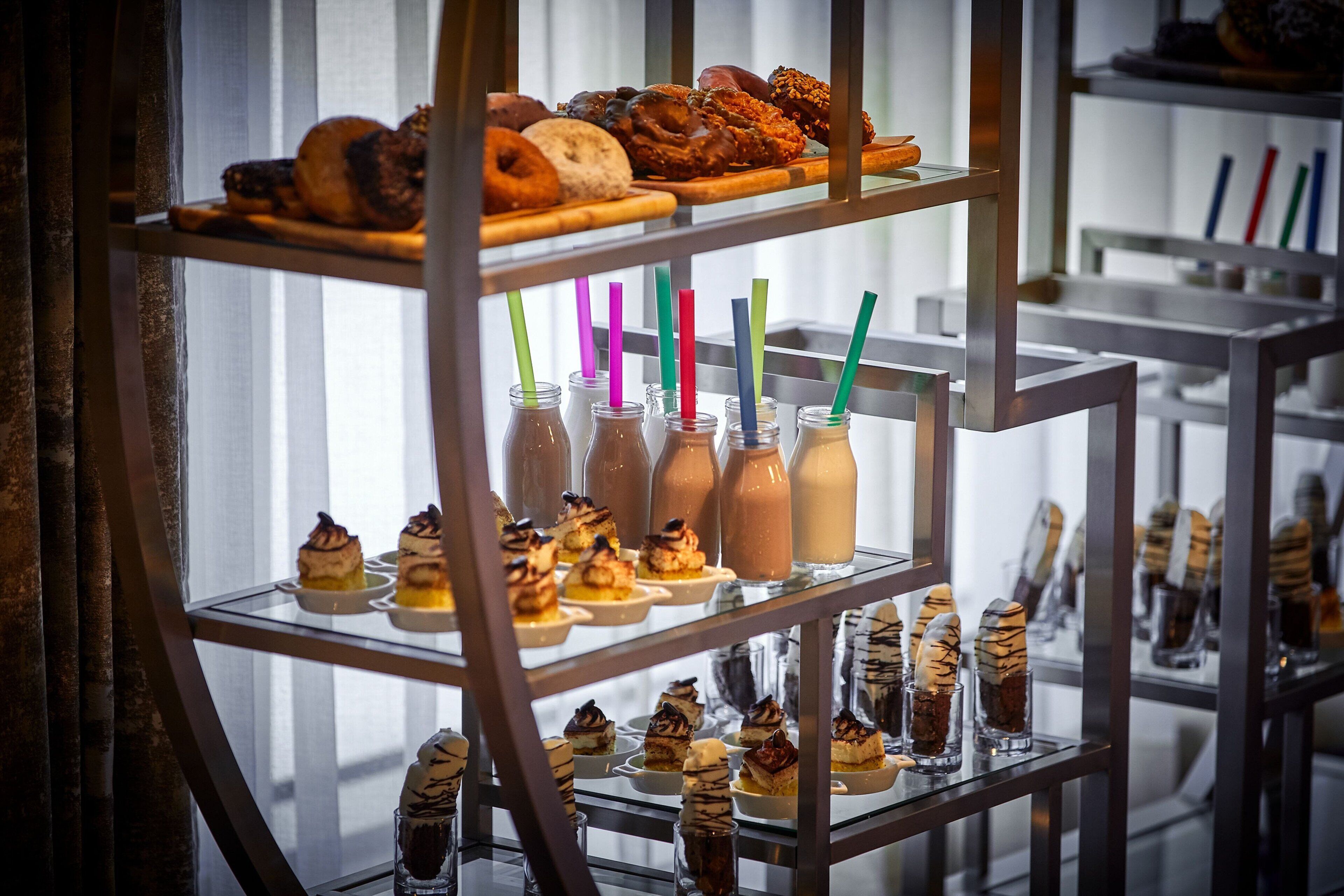 A dessert display with various pastries and drinks.