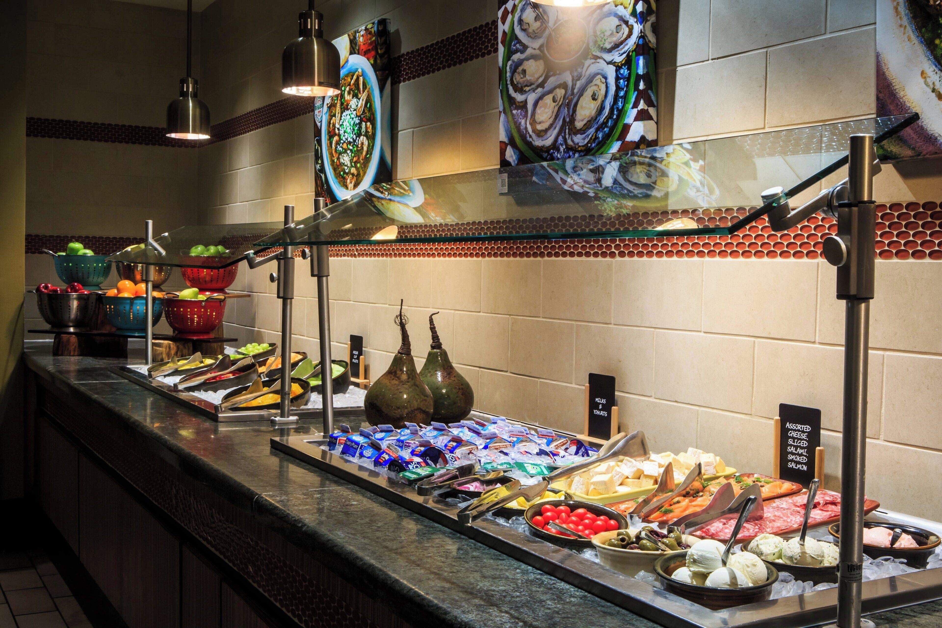 A buffet with various food items and condiments.