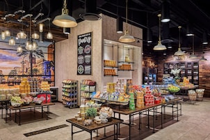 A bakery section with various baked goods and pastries displayed on tables and shelves.