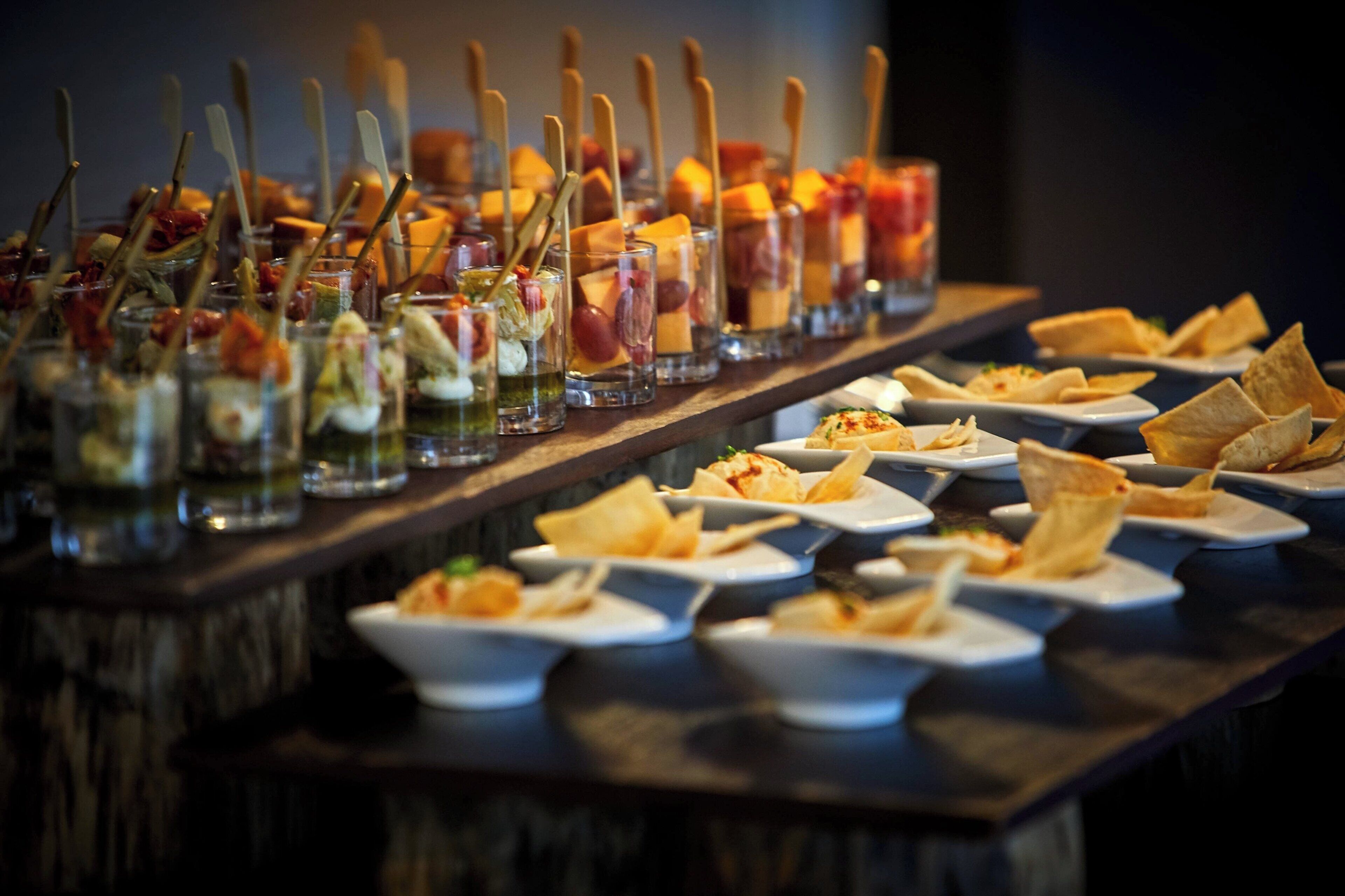 A buffet table with various dishes and drinks.