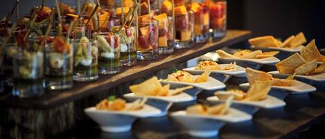 A buffet table with various dishes and drinks.