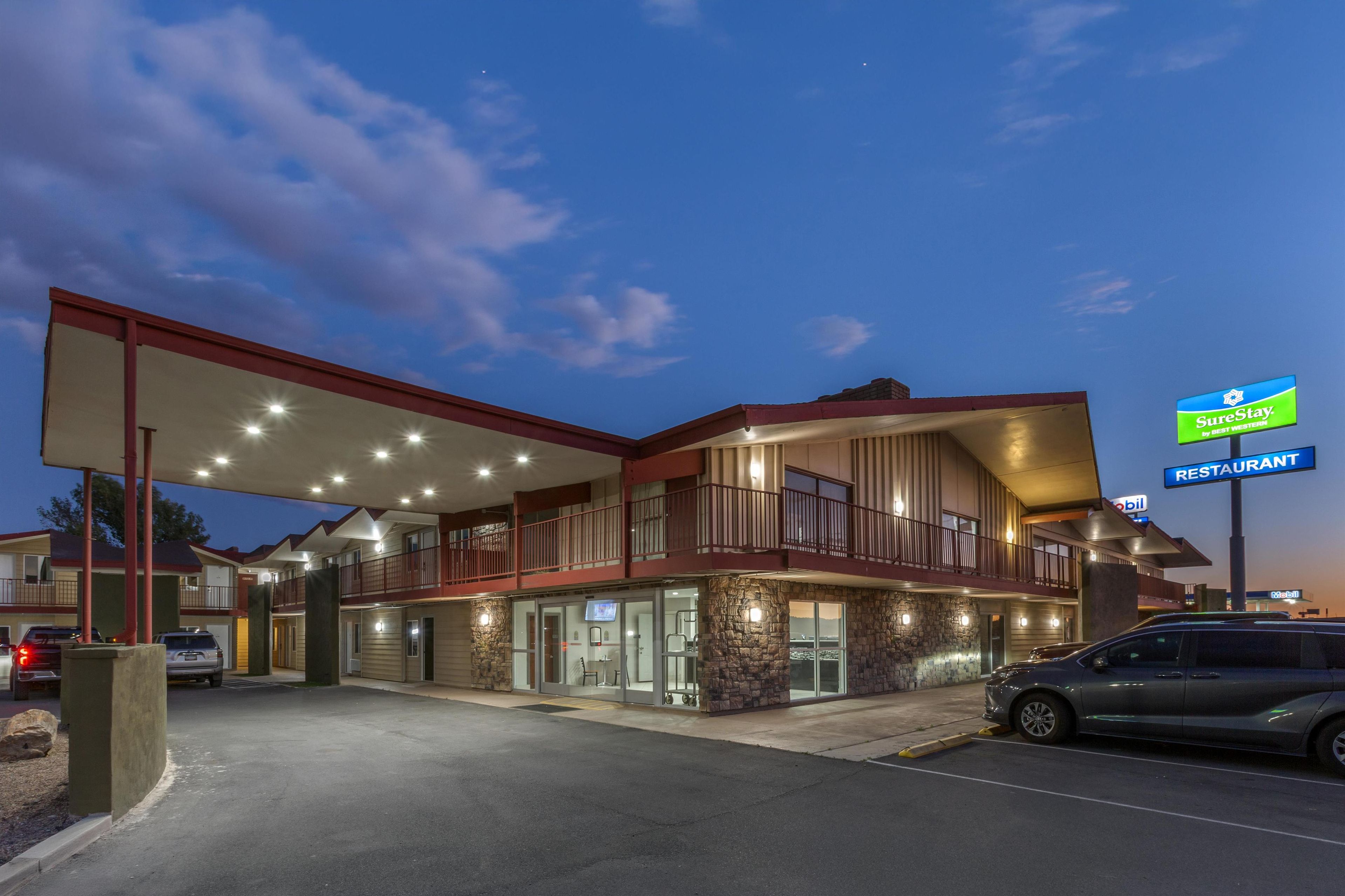 A hotel with a restaurant, a gas station, and a sign for SureStay.