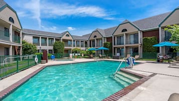 Seasonal outdoor pool, open 9:00 AM to 10:00 PM, pool umbrellas