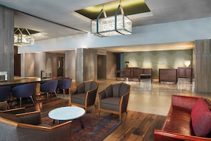 Relax in our spacious lobby with a central seating area, round table, and comfortable seating for all.